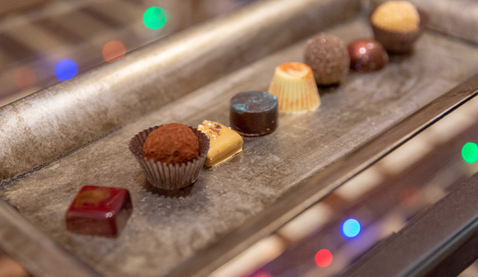 An array of gourmet chocolates on a silver tray