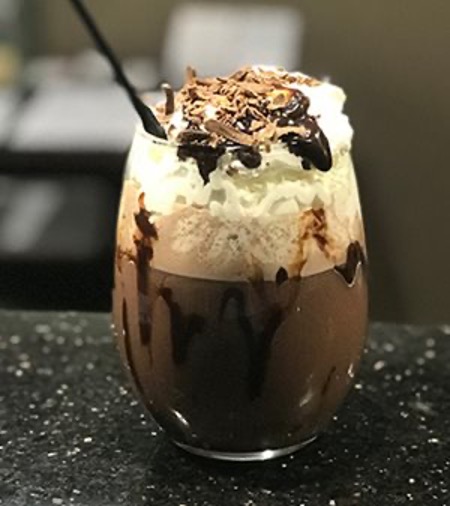Hot cocoa topped with whipped cream, chocolate sauce and shaved chocolate at Port City Pub at the Holiday Inn, Portsmouth