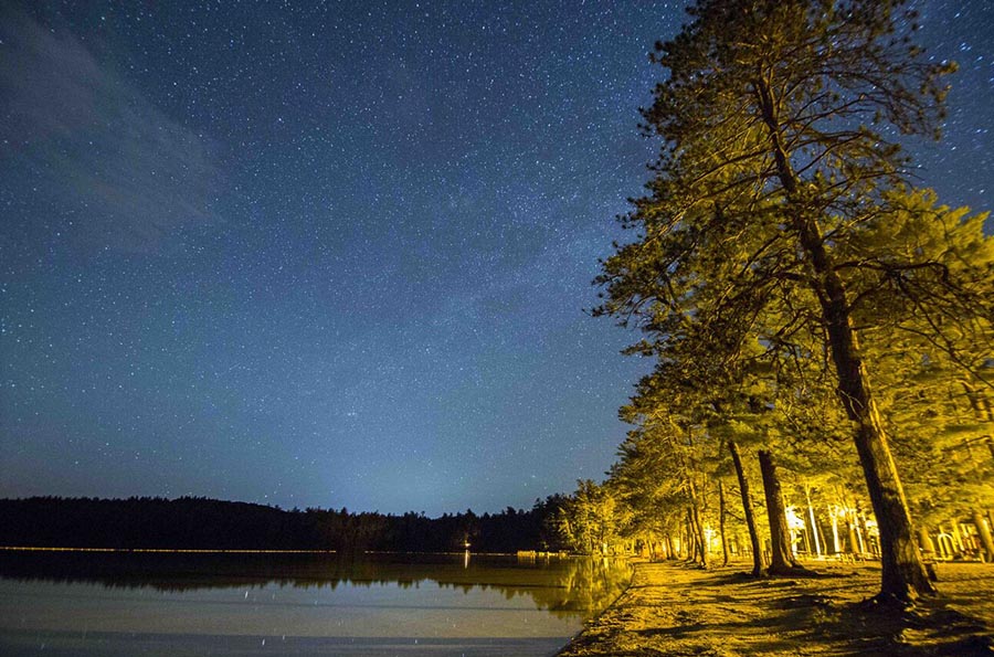 a starry sky over a lake