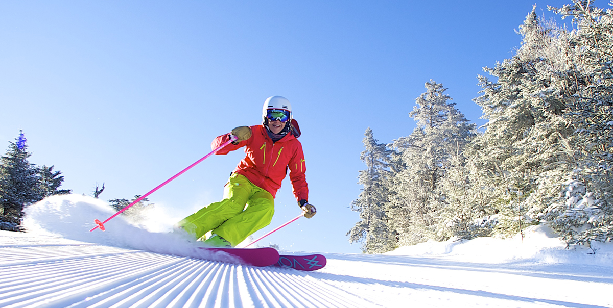 a woman skiing on a groomed trail