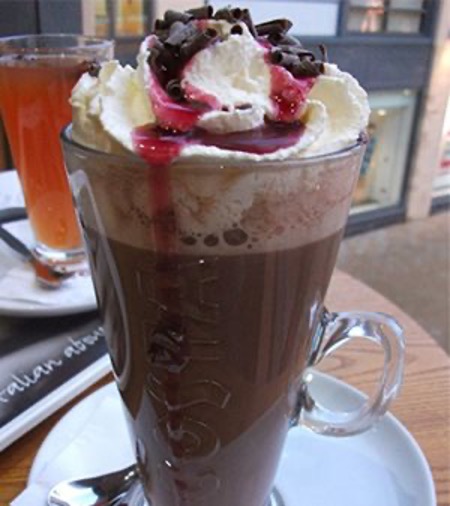 Hot cocoa topped with whipped cream, strawberry sauce and shaved chocolate at Giuseppe’s Pizzeria & Ristorante, Meredith